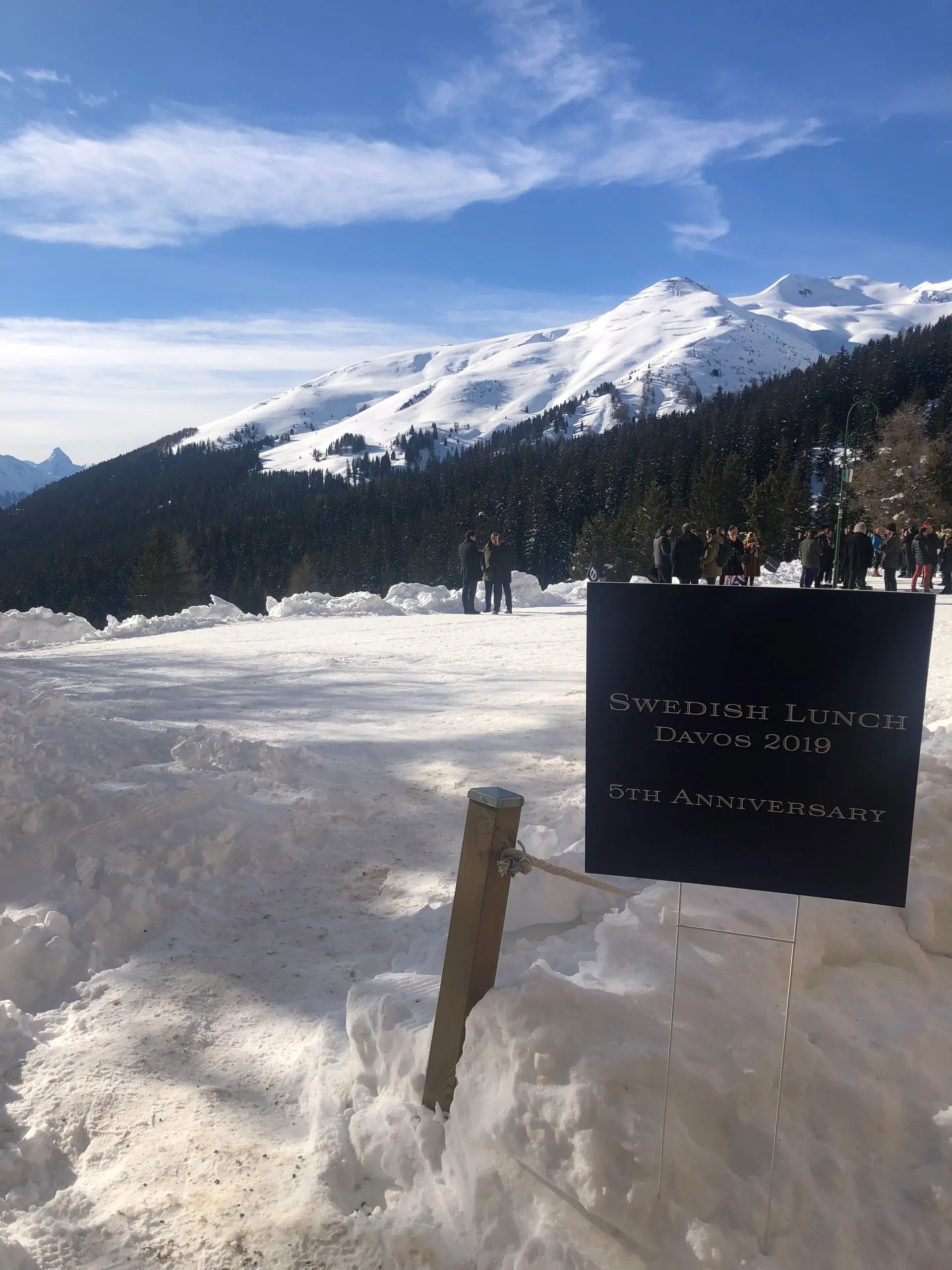 The Swedish Lunch sign at a past Davos edition, with guests gathered in the snow