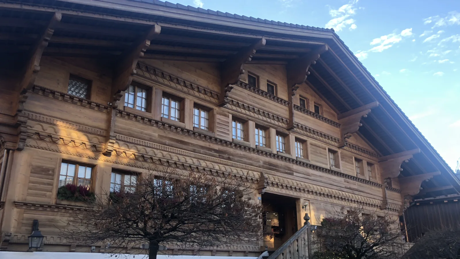 A traditional carved wooden Swiss chalet in winter sun